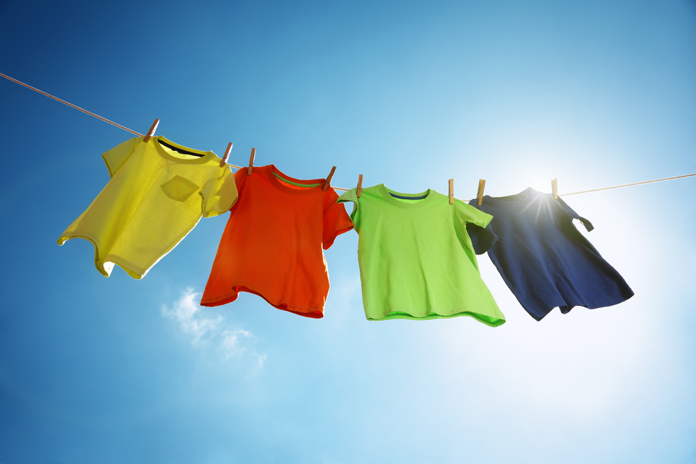 T-shirts,Hanging,On,A,Clothesline,In,Front,Of,Blue,Sky