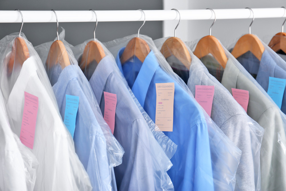 dry cleaned clothes on a rack