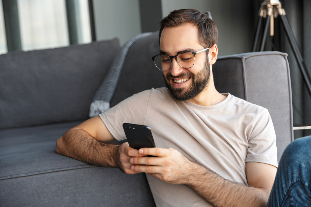 happy man using smartphone