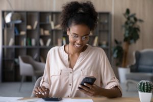 smiling woman using smartphone