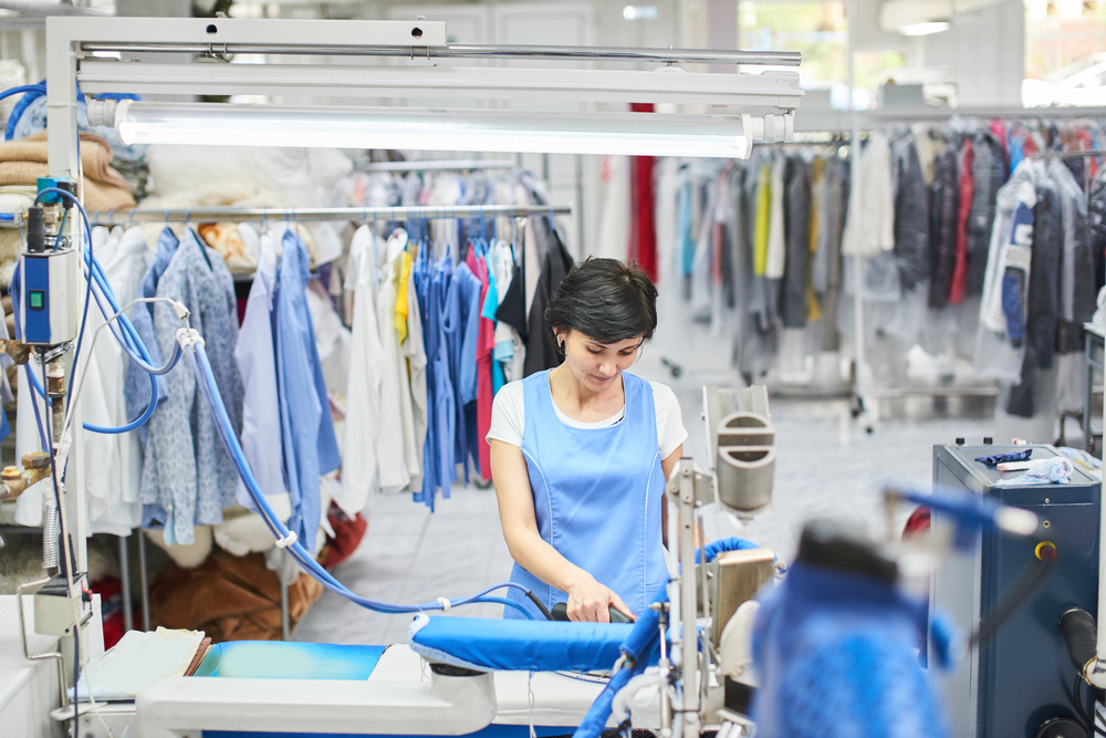 Worker ironing clothes